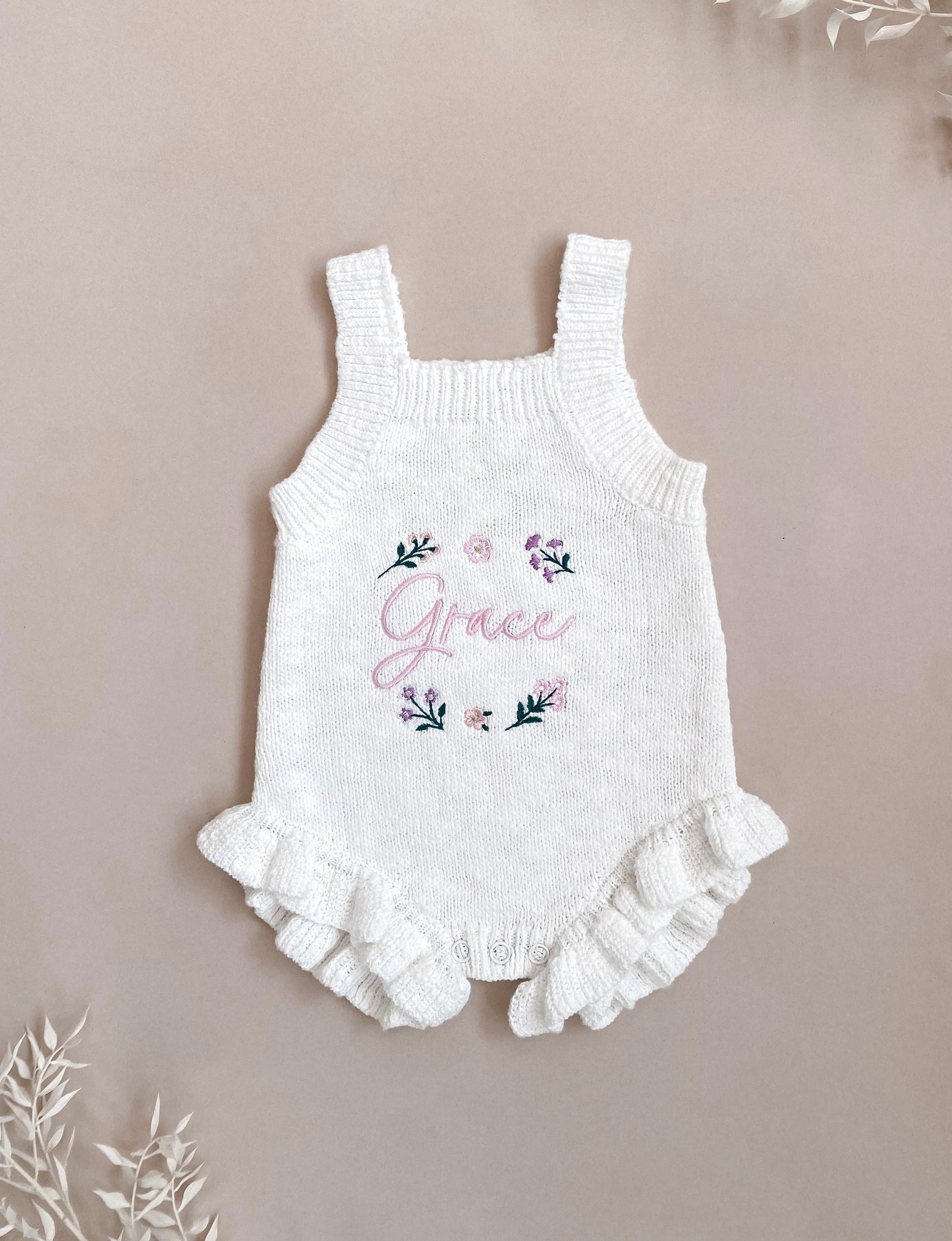Personalised ivory knit baby romper with embroidered floral design and frill legs,