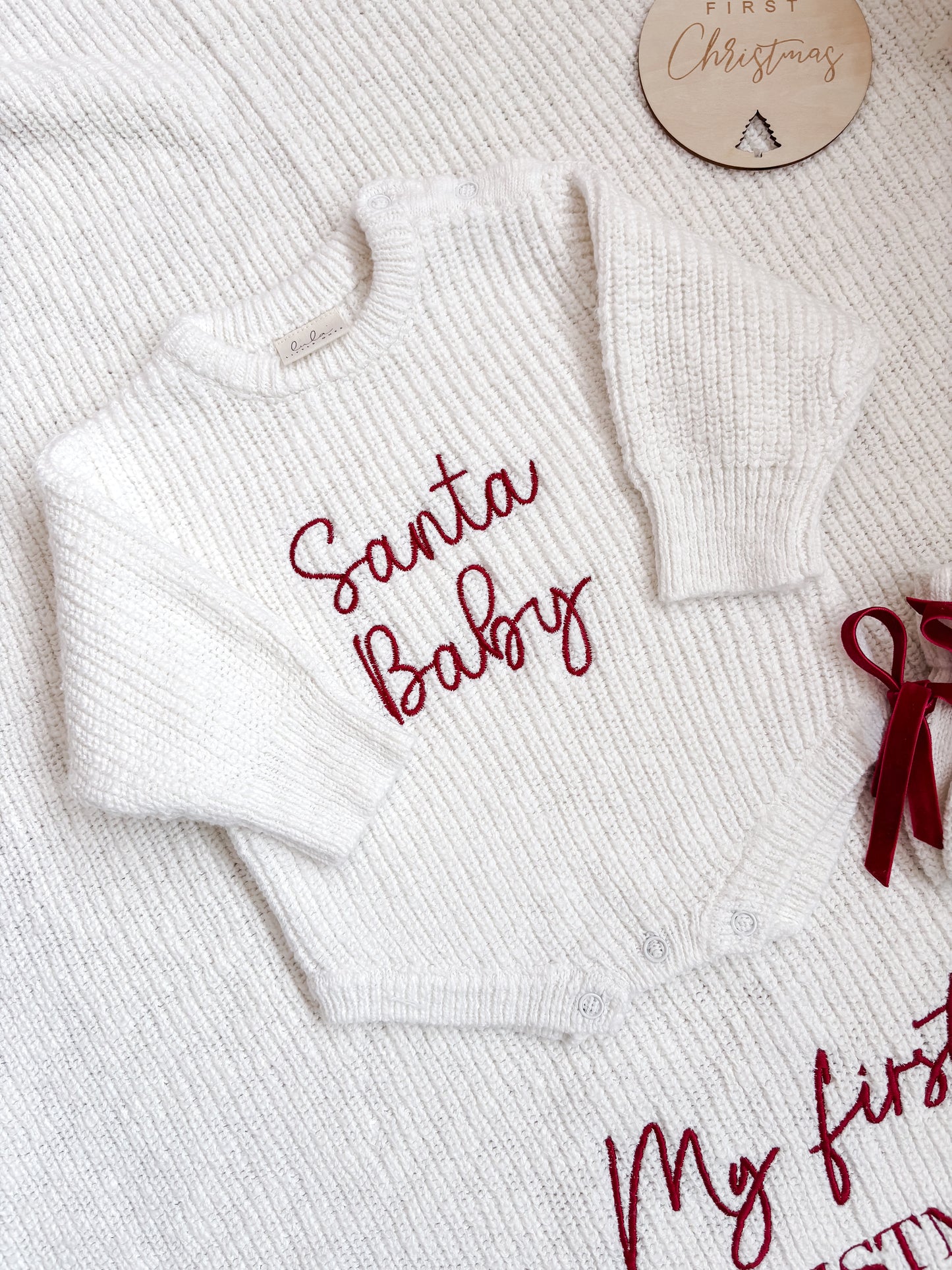 White baby romper with 'Santa Baby' embroidery
