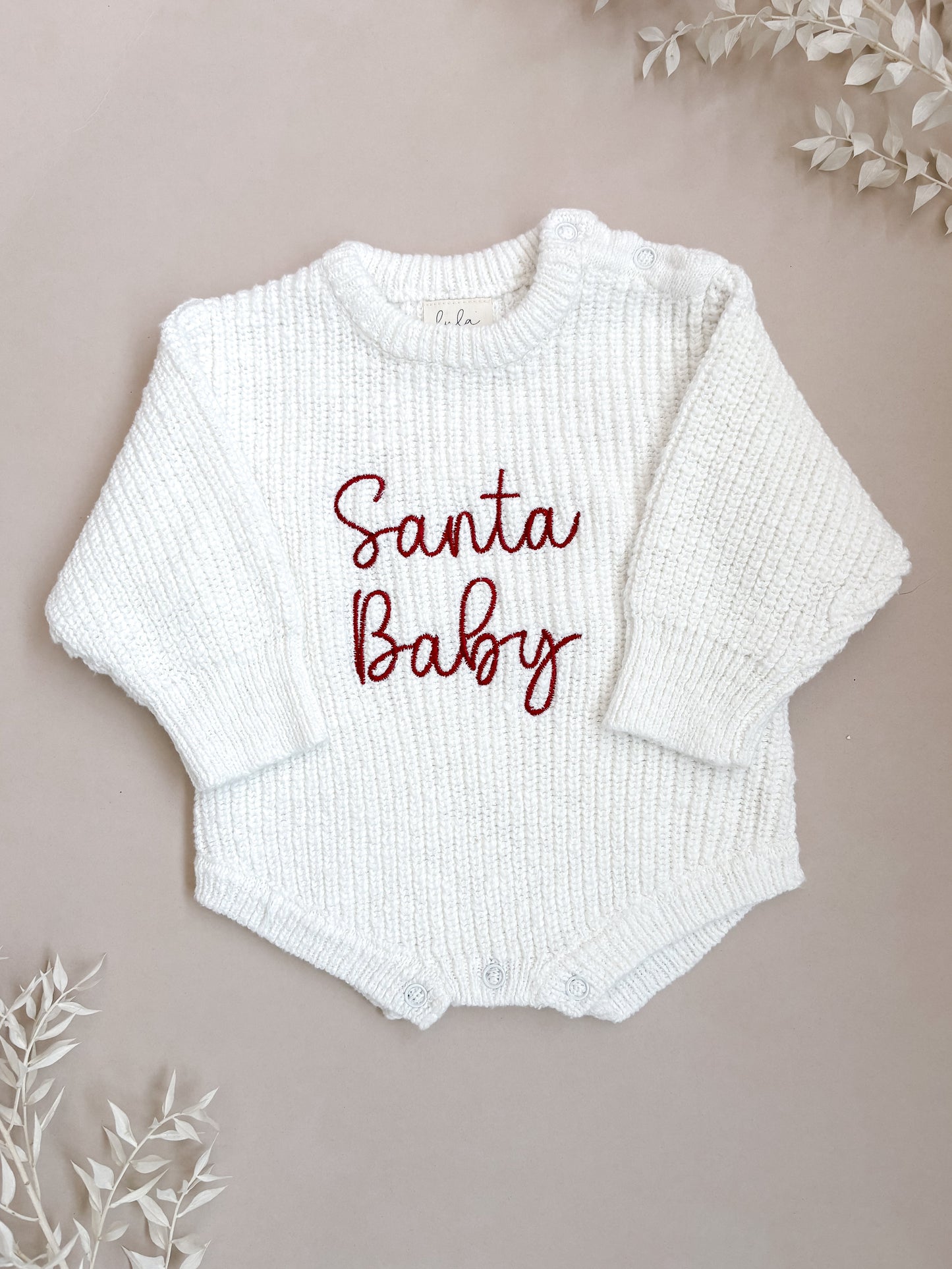 White baby romper with 'Santa Baby' embroidery
