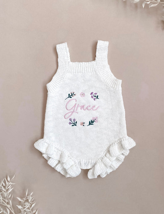 Personalised ivory knit baby romper with embroidered floral design and frill legs,