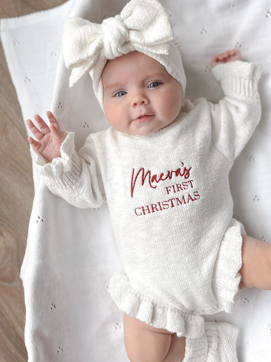 White baby romper with 'first Christmas' embroidery