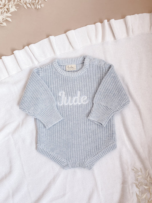 Light blue baby romper with 'Jude' embroidered in white

