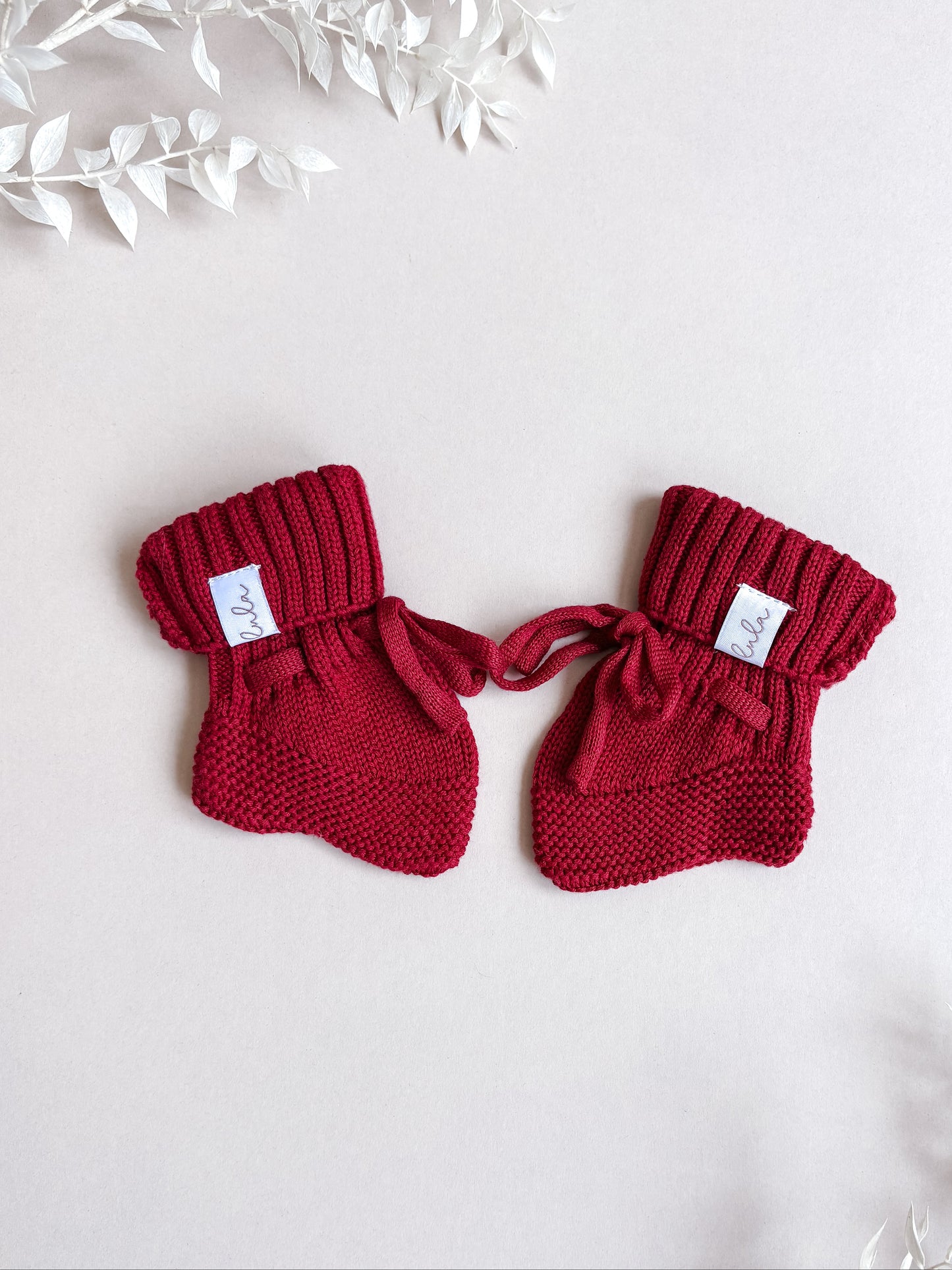 red knitted baby booties