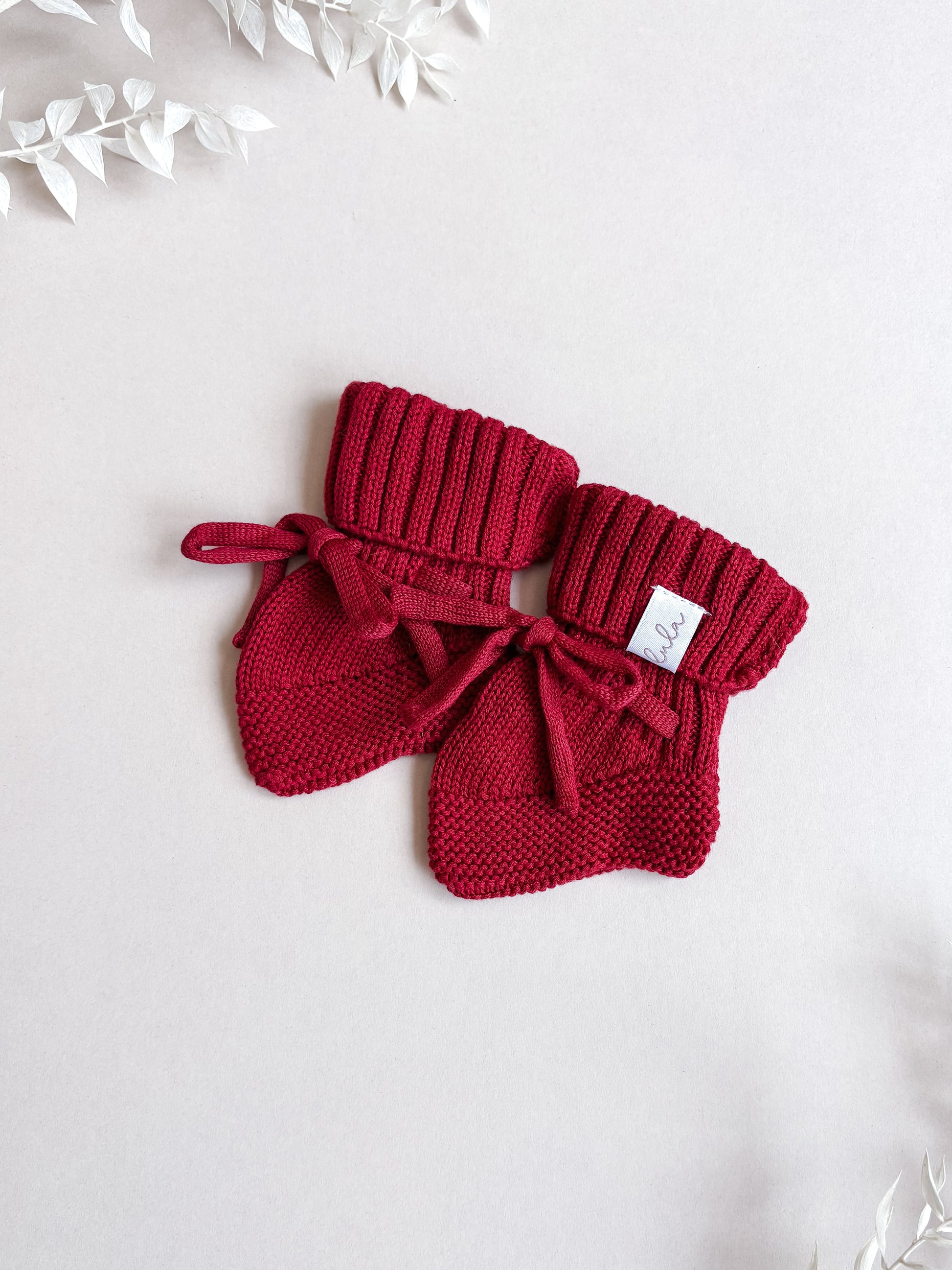 red knitted baby booties