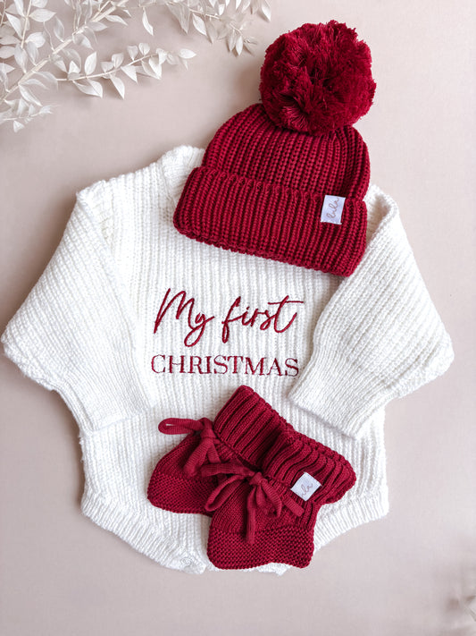 red knitted baby hat with pom pom