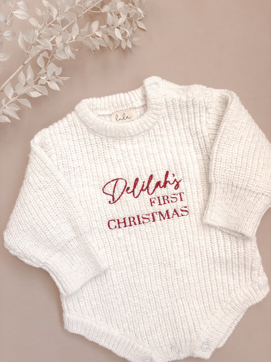 White baby romper with 'first Christmas' embroidery