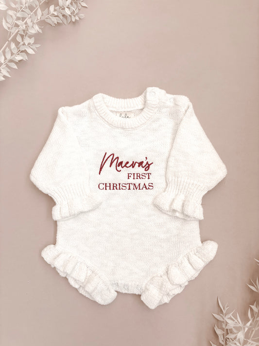White baby romper with 'first Christmas' embroidery