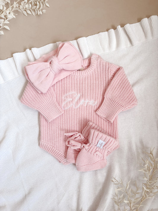 Pink chunky knit baby outfit with a bow and booties