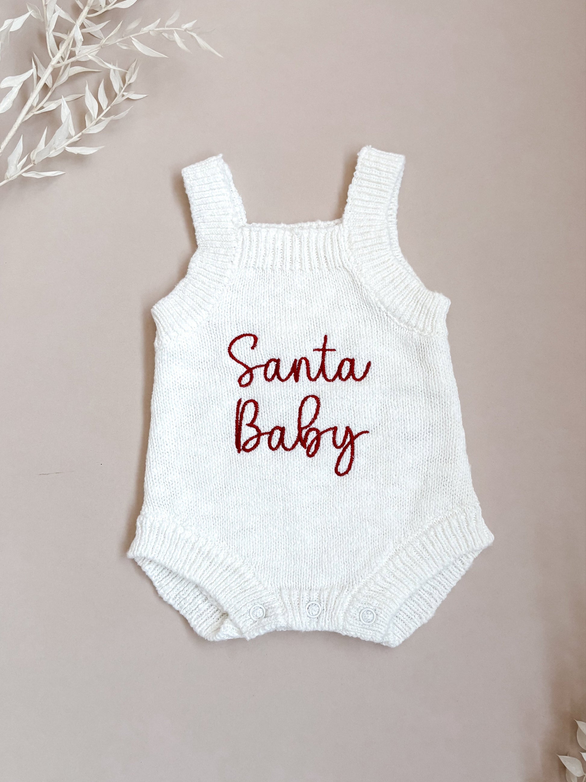 White baby romper with 'Santa Baby' embroidery