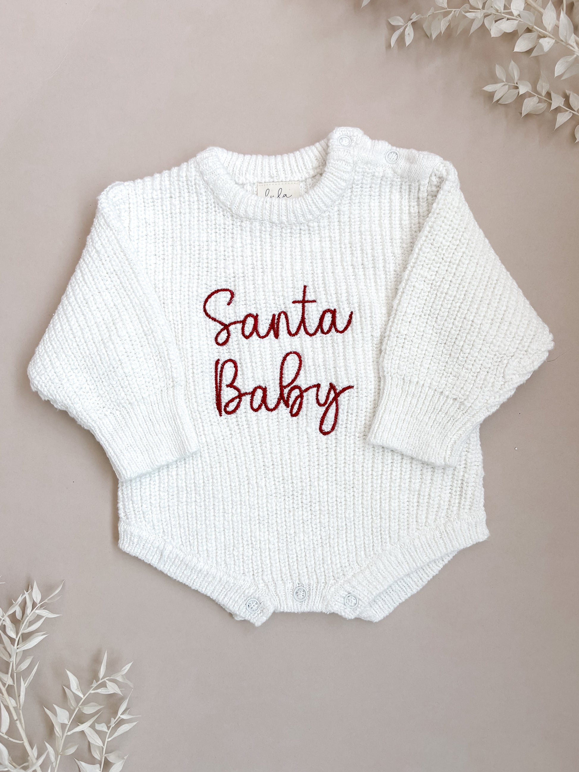 White baby romper with 'Santa Baby' embroidery