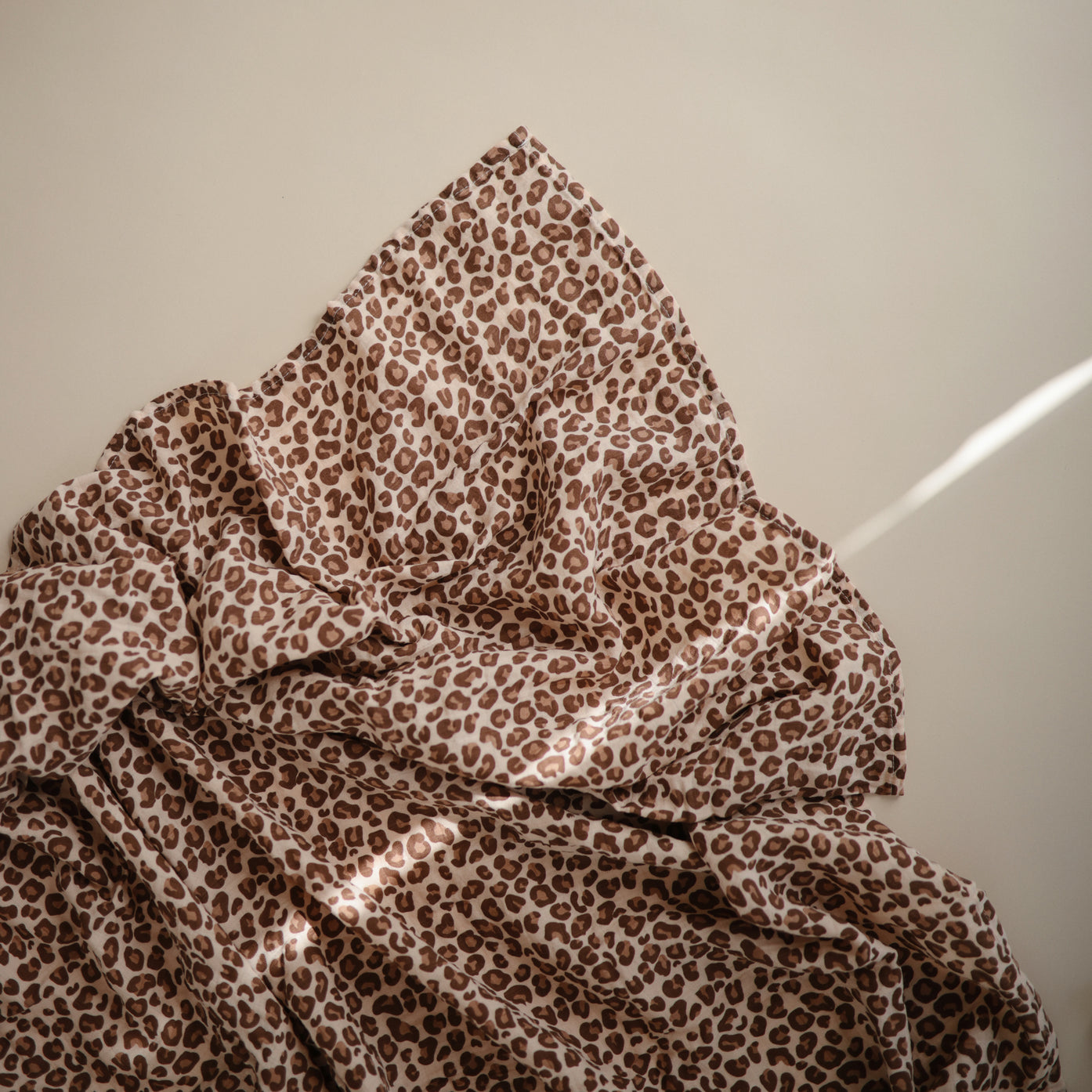 mushie leopard muslin swaddle blanket